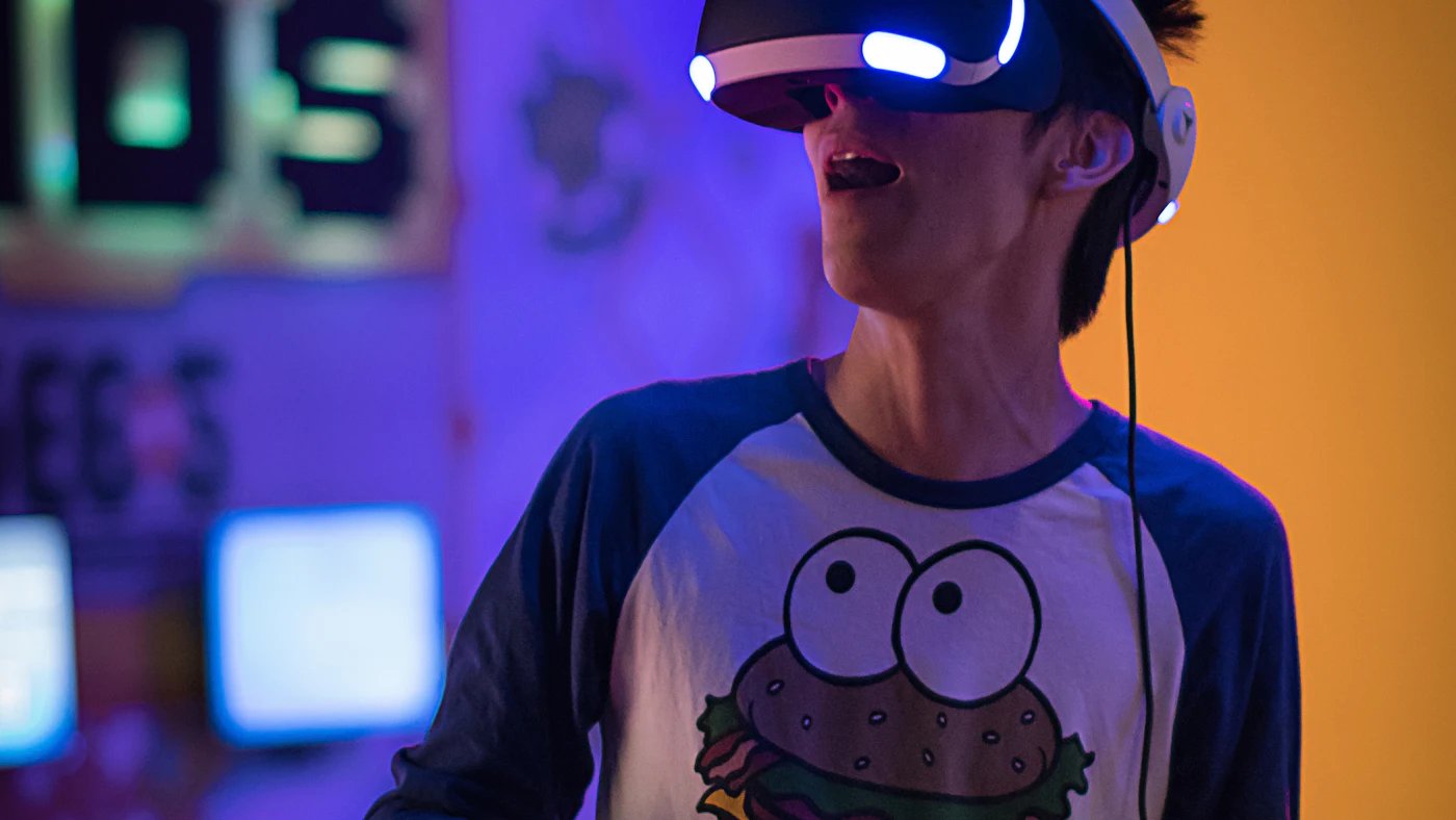 A person wearing a virtual reality headset with a surprised expression
